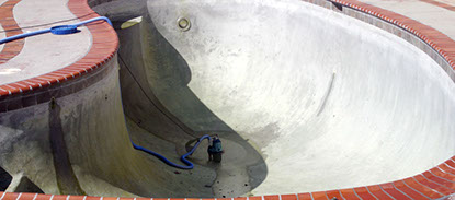 Black plaster pool with stains